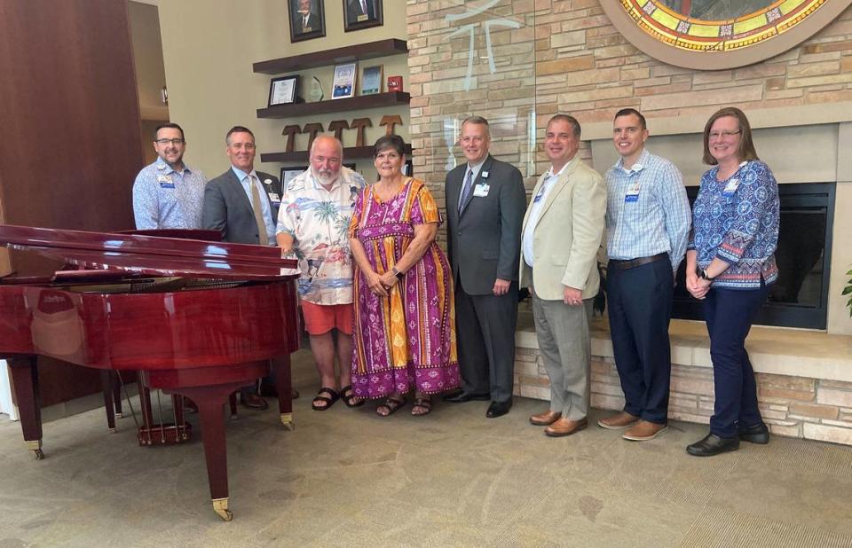 HSHS St. Joseph’s Hospital Highland recently accepted the gift of a grand piano from John and Cindy Ludwig. Shown by the piano at a recent brief ceremony are (left to right): Jed Driemeyer, director of human resources; Chris Klay, president and CEO; John and Cindy Ludwig; Dave Garris, director of philanthropy; Dr. Dennis Szurkus, chief medical officer; Mark Ennen, director of financial operations; and Teri Mustain, executive assistant.