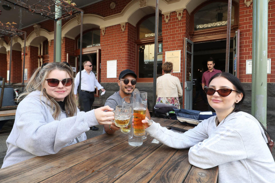 FREMANTLE, AUSTRALIA - MAY 18: Customers enjoy a beer at the National Hotel on May 18, 2020 in Fremantle, Australia. COVID-19 restrictions have further eased across Western Australia in response to the state's declining infection rate. From Monday 18 May, restaurants and cafes can open for up to 20 patrons to dine in, while indoor and outdoor gatherings of up to 20 people are also permitted. Regional travel boundaries have also been eased, with temporary regional borders reduced from 13 to four. Travel is permitted within the Mid-West, Gascoyne and Pilbara, the Goldfields-Esperance region and within the Kimberley. While travel between South West, Great Southern, Wheatbelt and Peel regions to Perth is also now permitted.Travel between Perth and the other regions remains prohibited, and Western Australia's interstate border also remains closed. (Photo by Paul Kane/Getty Images)