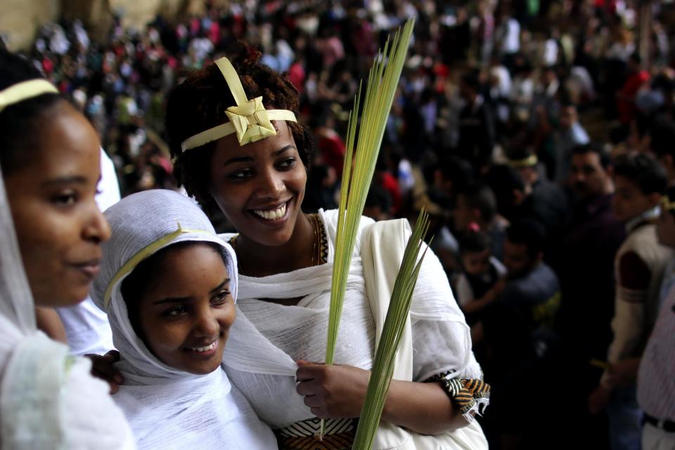 Egyptians celebrate Palm Sunday during a service in the Samaan el-Kharaz Church in the Mokattam district of Cairo, Egypt, Sunday, April 13, 2014. For Christians worldwide, Palm Sunday marks Jesus Christ's entrance into Jerusalem, when his followers laid palm branches in his path, prior to his crucifixion. (AP Photo/Roger Anis, El Shorouk) EGYPT OUT