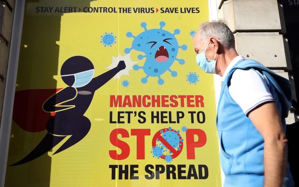 A sign in Manchester urges people to help prevent the spread of Covid-19 - Martin Rickett/PA