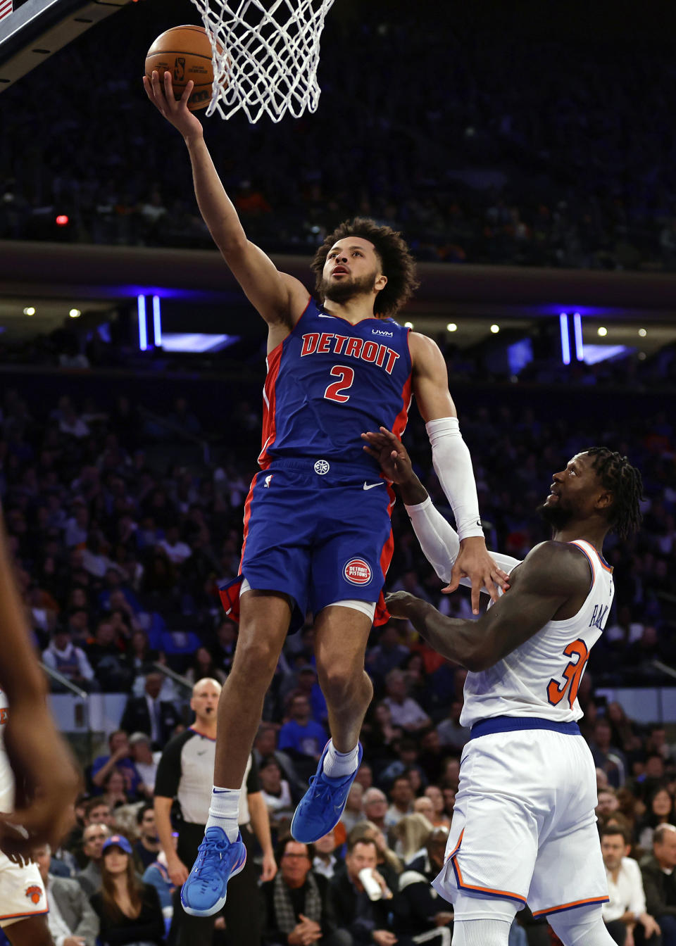 Detroit Pistons guard Cade Cunningham (2) drives to the basket past New York Knicks forward Julius Randle during the first half of an NBA basketball game Friday, Oct. 21, 2022, in New York. (AP Photo/Adam Hunger)