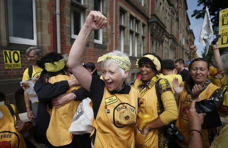 Anti-fracking protesters celebrate a rejected fracking planning application during a demonstration outside County Hall in Preston, Britain June 29, 2015. REUTERS/Andrew Yates