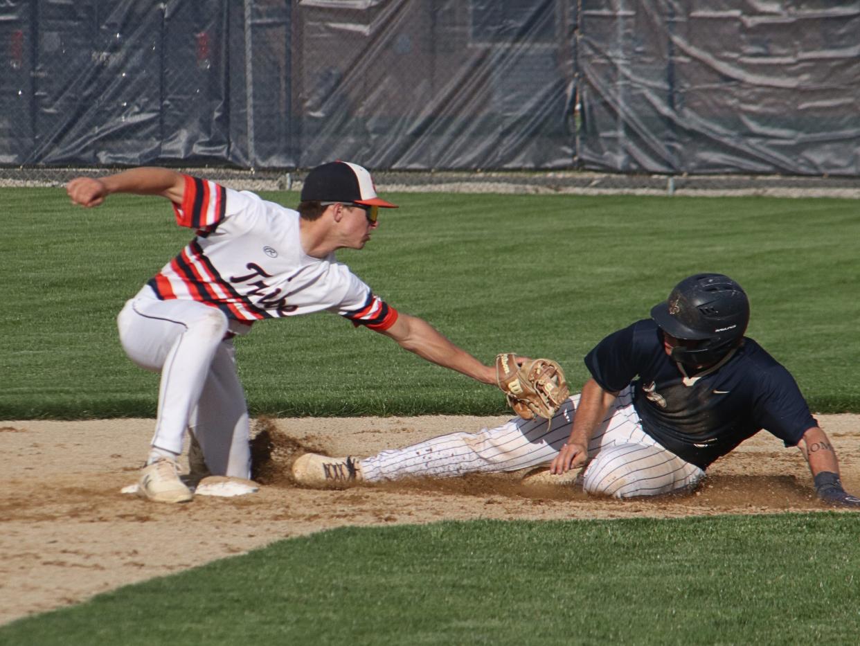 Pontiac second baseman Cayden Masching reaches to tag a Central Catholic baserunner during their Illini Prairie Conference game at The Ballpark at Williamson Field.