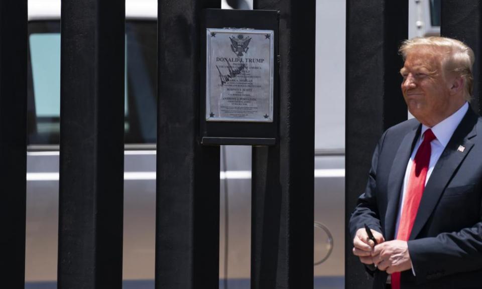 President Donald Trump autographs a section of the wall during a tour in San Luis, Arizona, 23 June 2020