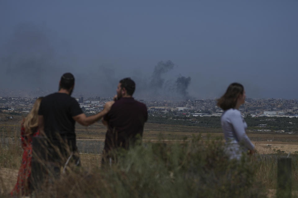 People watch smoke rising to the sky after an explosion in the Gaza Strip, as seen from southern Israel, Friday, May 17, 2024. (AP Photo/Tsafrir Abayov)
