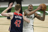 Milwaukee Bucks' Jeff Teague drives to the basket against Washington Wizards' Davis Bertans (42) during the second half of an NBA basketball game Wednesday, May 5, 2021, in Milwaukee. (AP Photo/Aaron Gash)