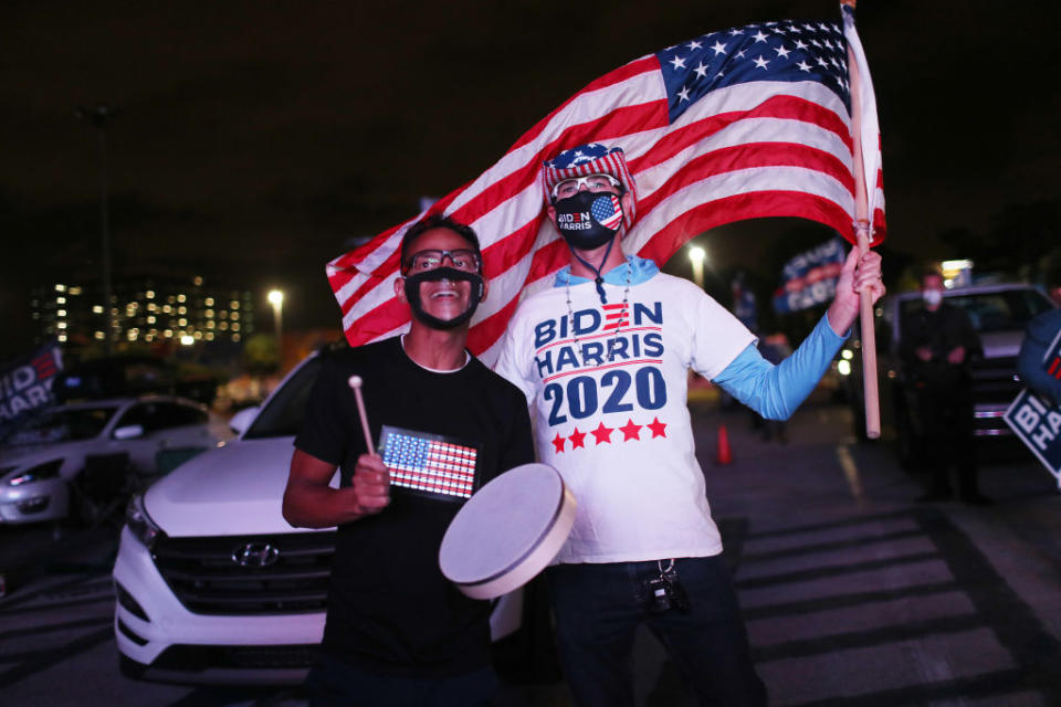 Alex Suarez (left) and Ralph Reichard watch a broadcast of CNN showing presidential election returns at an election night watch party.