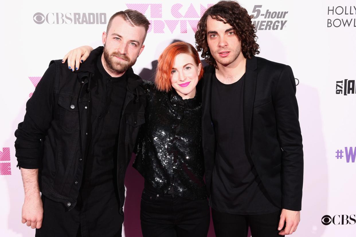 Jeremy Davis, singer Hayley Williams and musician Taylor York of Paramore pose backstage during CBS Radio's We Can Survive at the Hollywood Bowl on October 24, 2014 in Los Angeles, California.