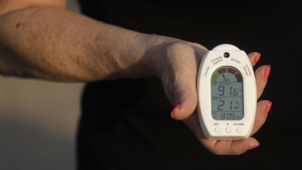 A RiteAid worker holds a heat and humidity index device that some workers wear when working at the RiteAid warehouse in Lancaster, California, on July 11, 2021. - Genaro Molina / Los Angeles Times/Getty Images