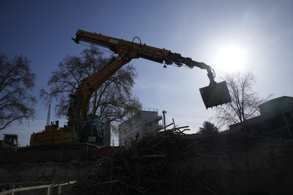 A bulldozer operates at a water storage tank construction site in Paris, Wednesday, April 5, 2023. A costly and complex clean-up is resuscitating the River Seine just in time for it to play a starring role in the 2024 Paris Olympics. The city and its region are rushing to make the Seine's murky waters swimmable, so it can genuinely live up to its billing as the world’s most romantic river. (AP Photo/Christophe Ena)