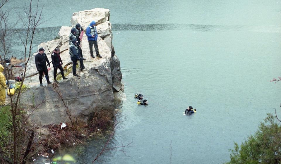 Divers from the Knoxville Volunteer Rescue Squad and the Knox County Sheriff's Office search for a car reportedly dumped in the 70-foot-deep murky waters of Mead's Quarry in 1993. Divers were hampered by an almost total lack of visibility in the chilly waters. That same murkiness makes it hard today to see what's on the bottom of the quarry.