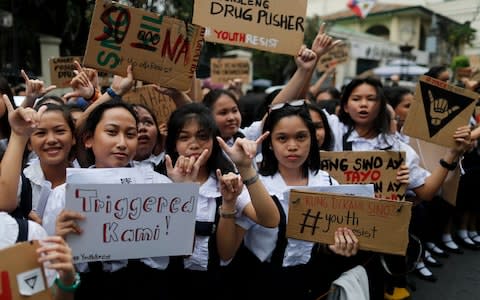 Filipino students stage a protest rally against the war on drugs in Manila - Credit: EPA