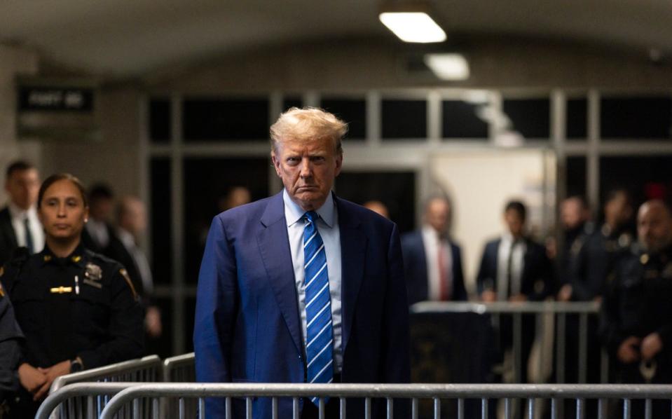 Trump talks to reporters after the second day of jury selection for his criminal trial at the New York State Supreme Court in New York on 16 April  2024 (EPA)