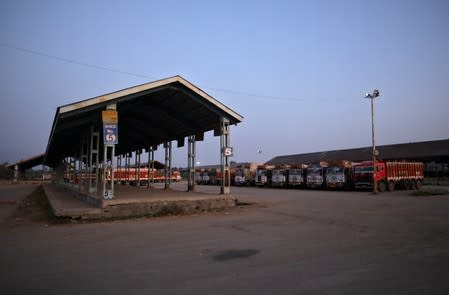 Supply trucks are parked inside closed Mustafa Memorial Fruit Mandi in Sopore