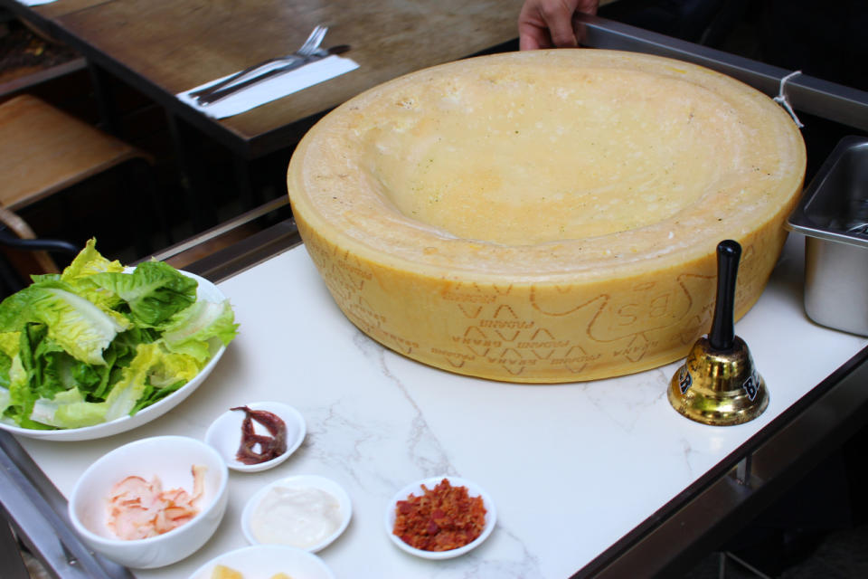 When a dish from the cheese wheel menu is ordered, a waiter will ring a bell and push a cart with the cheese wheel next to your table. The food is tossed and mixed in the wheel before it is served with cheese shavings. (Photo: Yahoo Singapore)