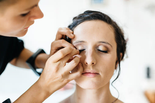 a makeup artists applying makeup on someone