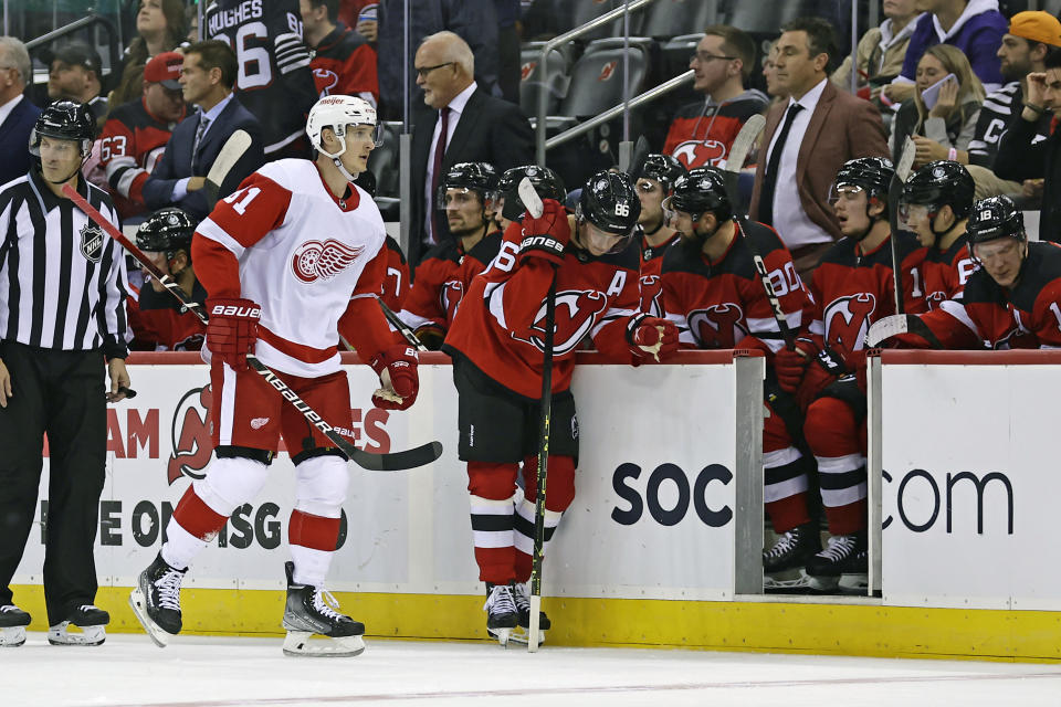 Detroit Red Wings left wing Dominik Kubalik skates past the New Jersey Devils bench after scoring a goal in the third period of an NHL hockey game Saturday, Oct. 15, 2022, in Newark, N.J. The Red Wings won 5-2. (AP Photo/Adam Hunger)