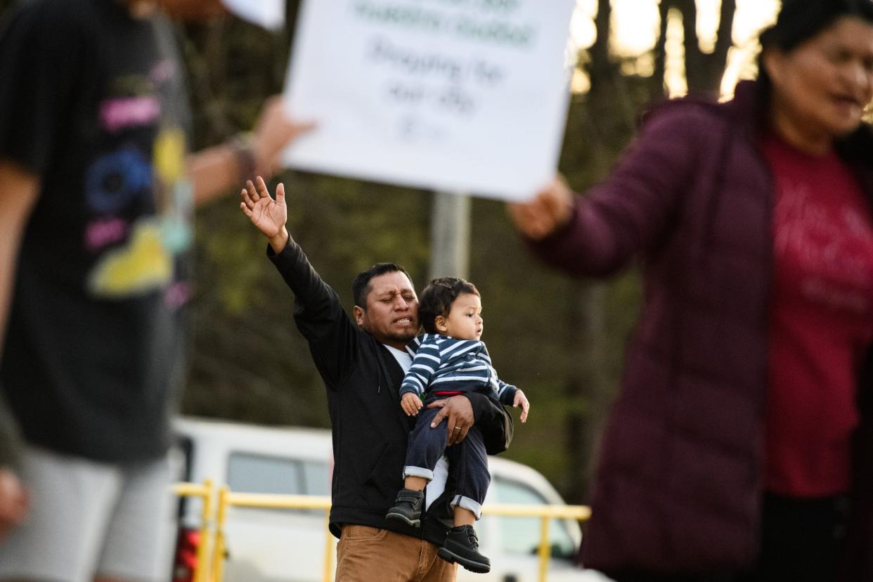 Members of CCI Greenville Church pray in front of Tanglewood Middle School the day after a fatal shooting occurred on campus Friday, April 1, 2022. 