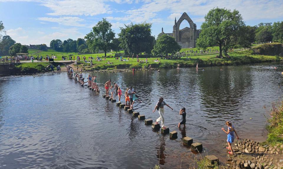 People enjoy the sunshine at Bolton Abbey in Yorkshire, as forecasters predict the high temperatures are set to continue through the weekend, peaking as high as 33C on Saturday. Picture date: Saturday September 9, 2023.