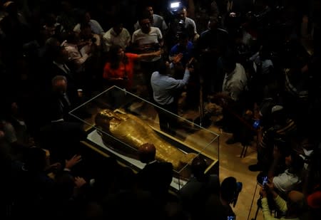 The Gold Coffin of Nedjemankh surrounded by members of media during a news conference to announce its return from the U.S. and display at the National Museum of Egyptian Civilization (NMEC) in Cairo