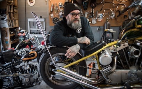 Ricky Reyes in Anchor Moto, his workshop in Kansas City. Ricky is a motorcycle builder, he takes old motorcycles engines and parts and creates new 'choppers' - Credit: Neville Elder for The Telegraph