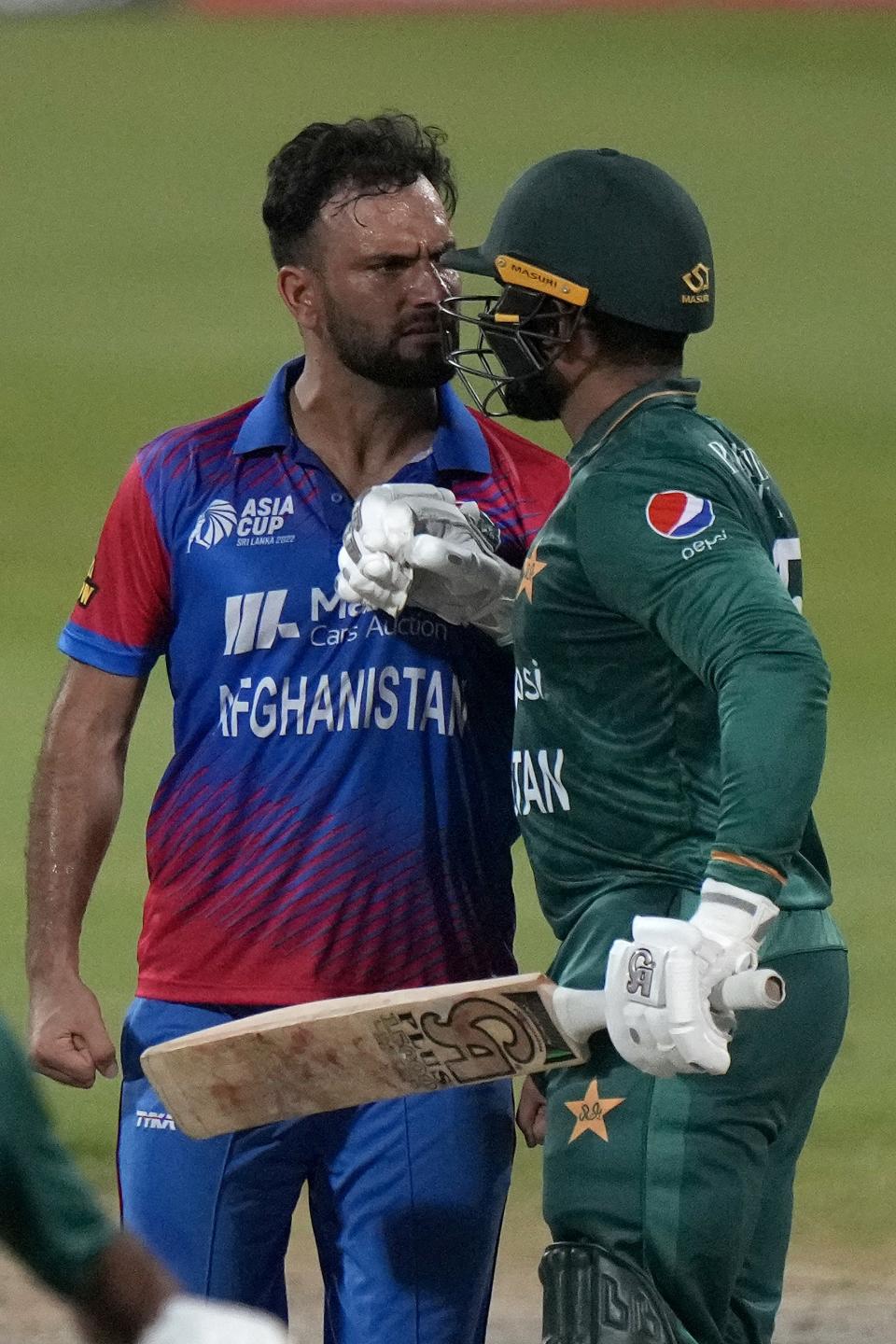 Afghanistan's Fareed Ahmad, left, and Pakistan's Asif Ali, right, react after Ali was dismissed by Ahmad during the T20 cricket match of Asia Cup between Pakistan and Afghanistan, in Sharjah, United Arab Emirates, Wednesday, Sept. 7, 2022. (AP Photo/Anjum Naveed)