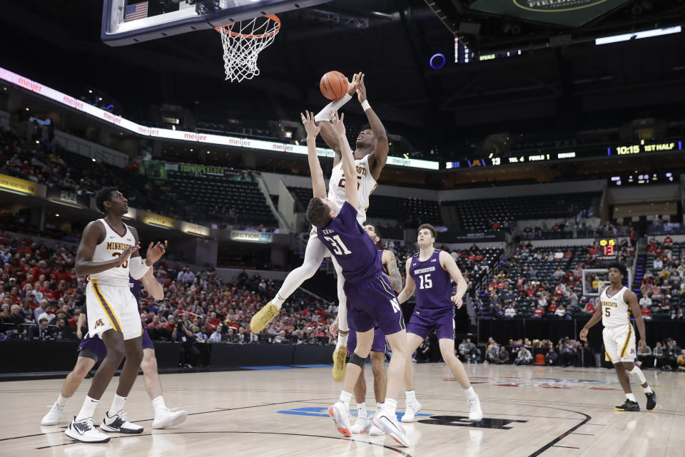 Northwestern's Robbie Beran (31) is called for a foul against Minnesota's Daniel Oturu (25) during the first half of an NCAA college basketball game at the Big Ten Conference tournament, Wednesday, March 11, 2020, in Indianapolis. (AP Photo/Darron Cummings)