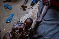 People shelter inside a school after their settlement was burned down by gangs, in Port-au-Prince