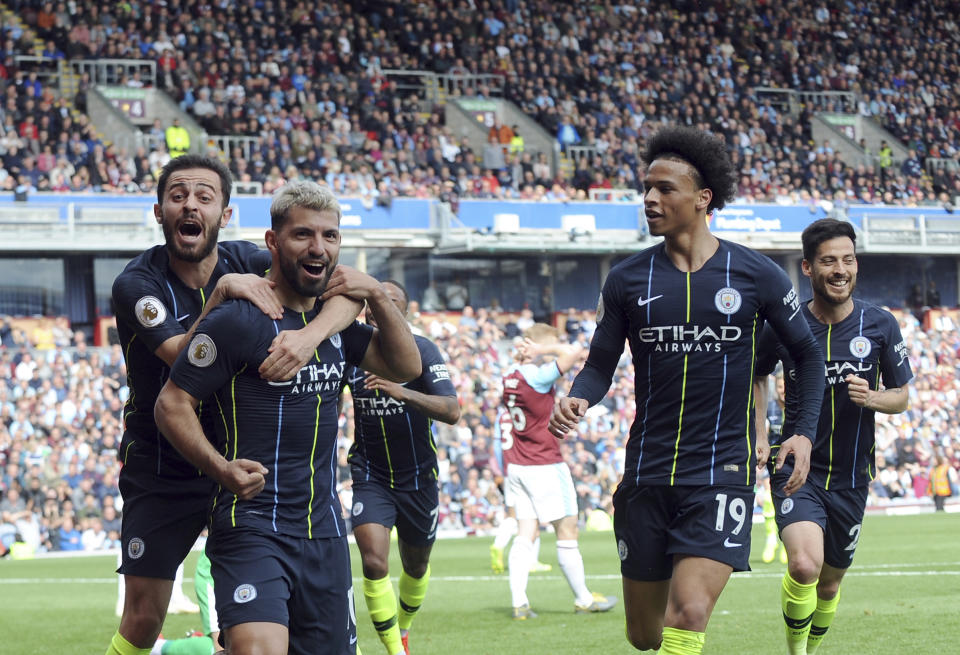 Manchester City's Sergio Aguero, second left, celebrates with teammates after scoring his side's opening goal during the English Premier League soccer match between Burnley and Manchester City at Turf Moor in Burnley, England, Sunday, April 28, 2019. (AP Photo/Rui Vieira)