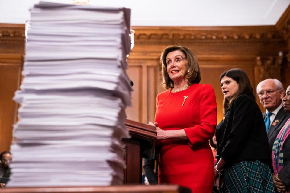 Nancy Pelosi gestures to a stack of bills the Democratic-controlled House of Representatives under her leadership has sent to the Senate in 2019.