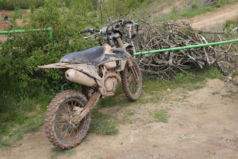 dirty motorcycle crashed into a fence