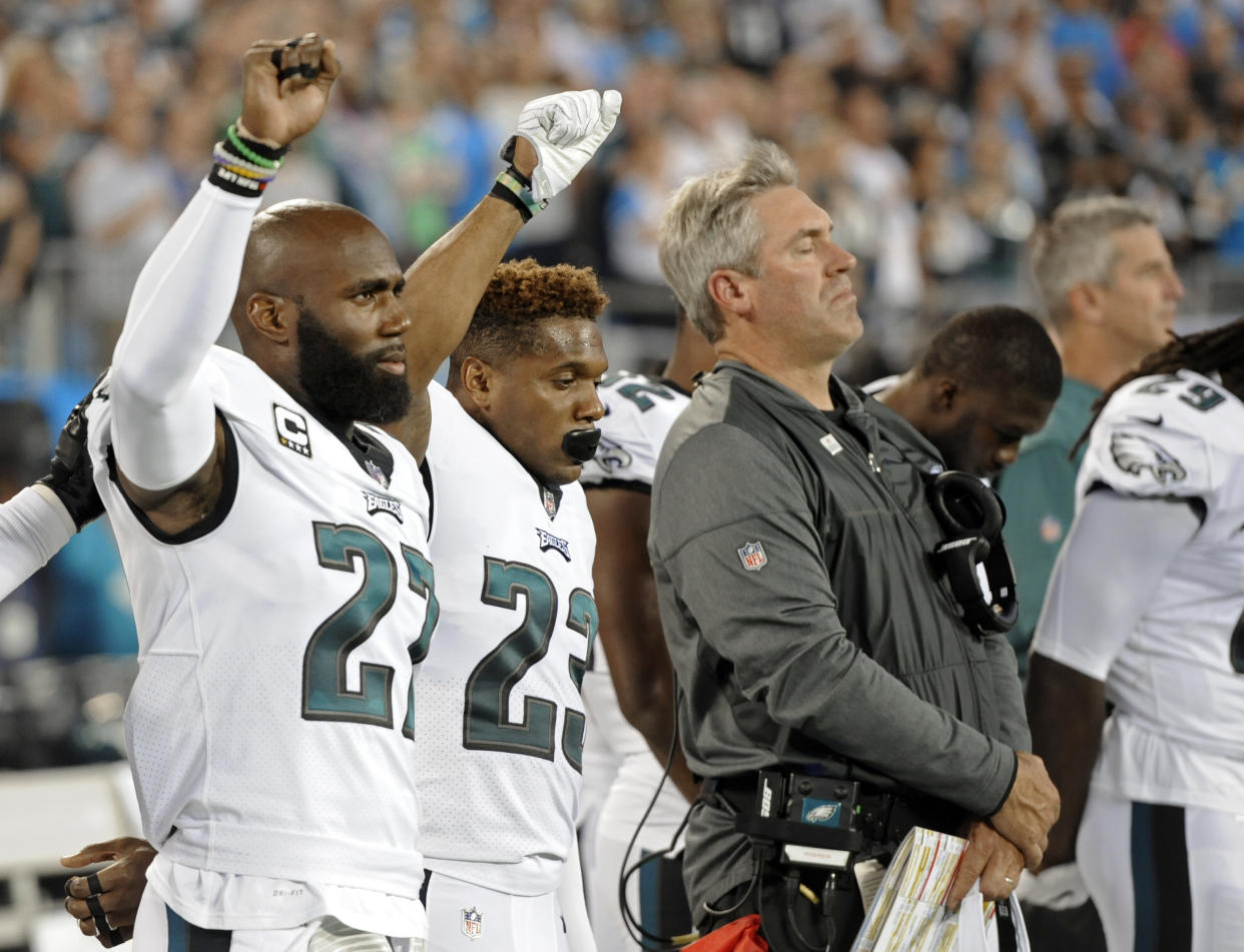 Eagles players raise a fist during the national anthem last season. Players were demonstrating to bring attention to social issues. (AP)