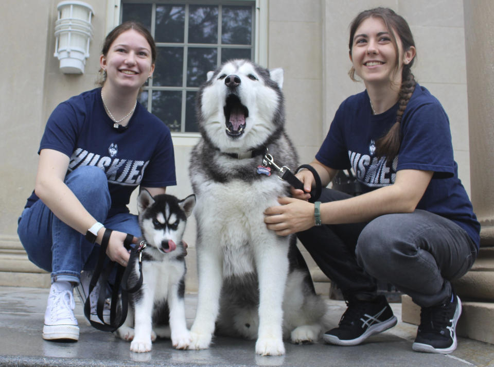 UConn students, from left, Jenna Epstein and Laura Centanni pose with UConn mascots Jonathan XIV and Jonathan XV outside the school's board of trustees on Wednesday June 28, 2023 U in Storrs, Conn. (AP Photo/Pat Eaton-Robb)