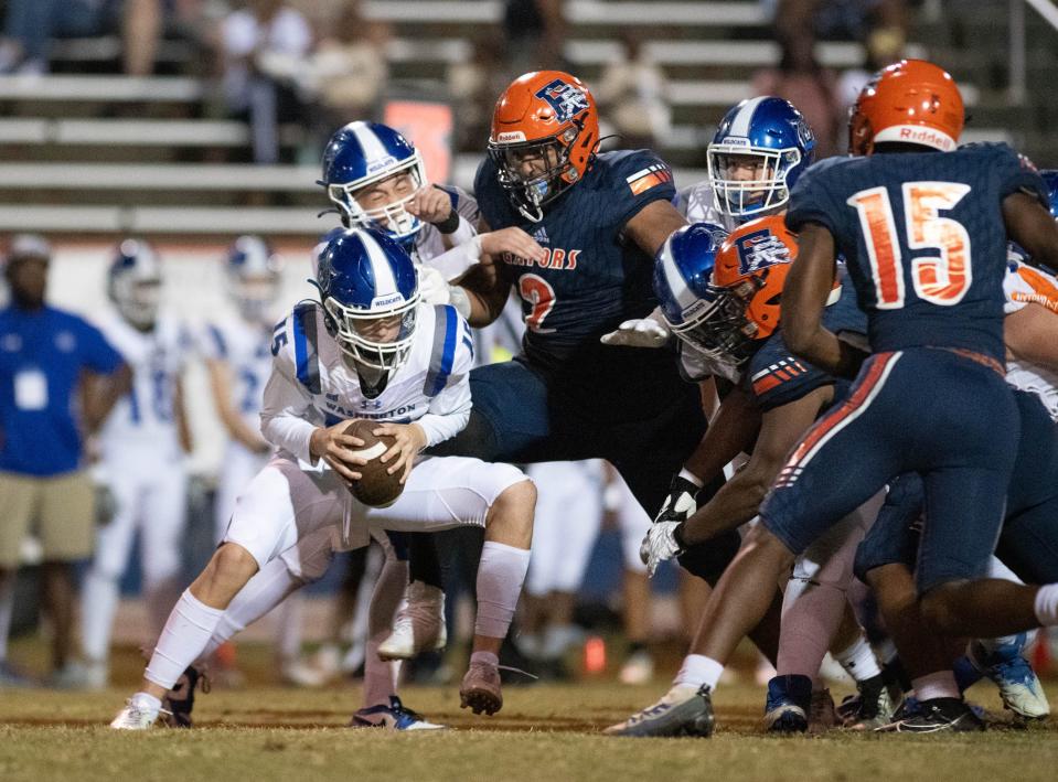 The Gators defense descends on Austin Smith (15) for a sack to end the first half during the Washington vs Escambia football game at Escambia High School in Pensacola on Friday, Sept. 29, 2023.
