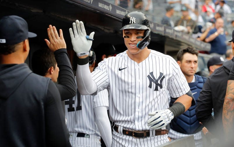 Aaron Judge #99 of the New York Yankees celebrates his fourth inning home run during game one of a doubleheader against the Minnesota Twins in the dugout with his teammates at Yankee Stadium on September 07, 2022 in the Bronx borough of New York City.
