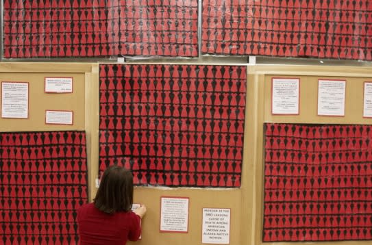 An art installation called "No More Stolen Sisters," an iteration of the Red Dress Project commemorating missing and murdered Indigenous women, is displayed at the University of Oregon in 2019. (Melanie Henshaw/Investigate/West) 