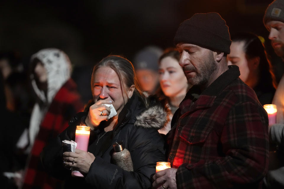 Mourners attend a candlelight vigil for Alexandria Verner at the Clawson High School football field in Clawson, Mich., Tuesday, Feb. 14, 2023. Verner was among the students killed after a gunman opened fire on the campus of Michigan State University Monday night. (AP Photo/Paul Sancya)