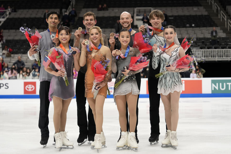 Spencer Howe, Emily Chan, Brandon Frazier, Alexa Knierim, Danny O'Shea, Ellie Kam, Daniel Tioumentsev and Sonia Baram, from left, hold their medals after the pairs free skate at the U.S. figure skating championships in San Jose, Calif., Saturday, Jan. 28, 2023. Knierim and Frazier finished first, Howe and Chan finished second, Kam and O'Shea finished third, and Baram and Tioumentsev finished fourth in the event. (AP Photo/Tony Avelar)