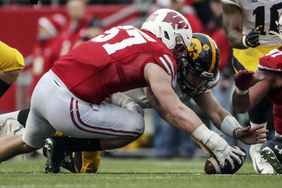 FILE - In this Nov. 9, 2019, file photo, Wisconsin's Jack Sanborn recovers a fumble in front of Iowa's Nate Stanley during the first half of an NCAA college football game in Madison, Wis. Wisconsin traditionally wins games primarily because of its running game and defense. Now that Jonathan Taylor has moved on to the NFL, that would seem to put more pressure on the defense to carry the load as the Badgers’ offense adjusts to life without the two-time Doak Walker Award winner. The defense looks forward to that challenge. (AP Photo/Morry Gash, File)