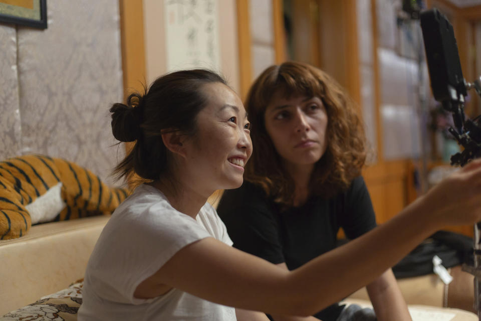 This image released by A24 shows director Lulu Wang, left, on the set of "The Farewell." Women directed 12 of 2019’s top 100-grossing films in 2019, according to a study released Thursday by USC Annenberg Inclusion Initiative Female filmmakers. (Casi Moss/A24 via AP)