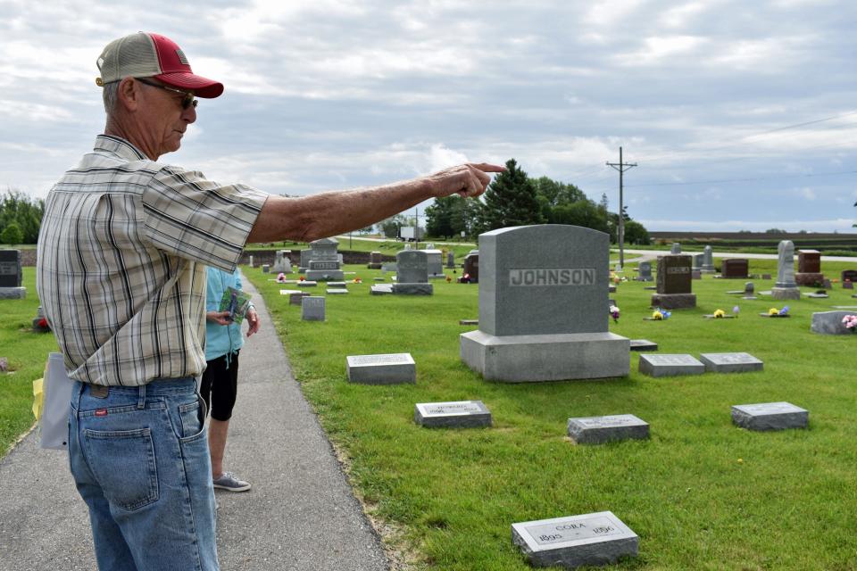 Dennis Michell points out parts of Bethlehem Lutheran Church Cemetery in Slater, where more than 50 headstones have been cleaned and straightened.