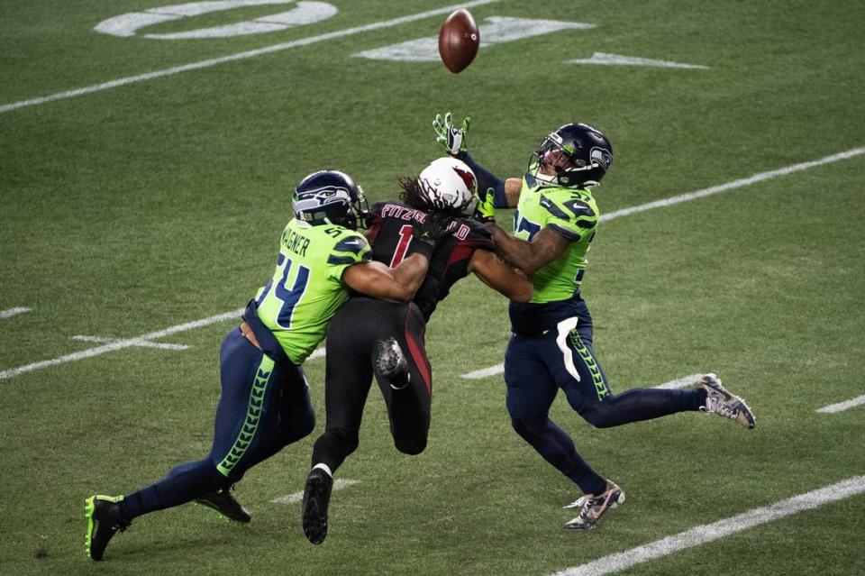 Seattle Seahawks linebacker Bobby Wagner and Seattle Seahawks defensive back Quandre Diggs break up a pass to Arizona Cardinals wide receiver Larry Fitzgerald during the fourth quarter. The Seattle Seahawks played the Arizona Cardinals in a NFL football game at Lumen Field in Seattle, Wash., on Thursday, Nov. 19, 2020.