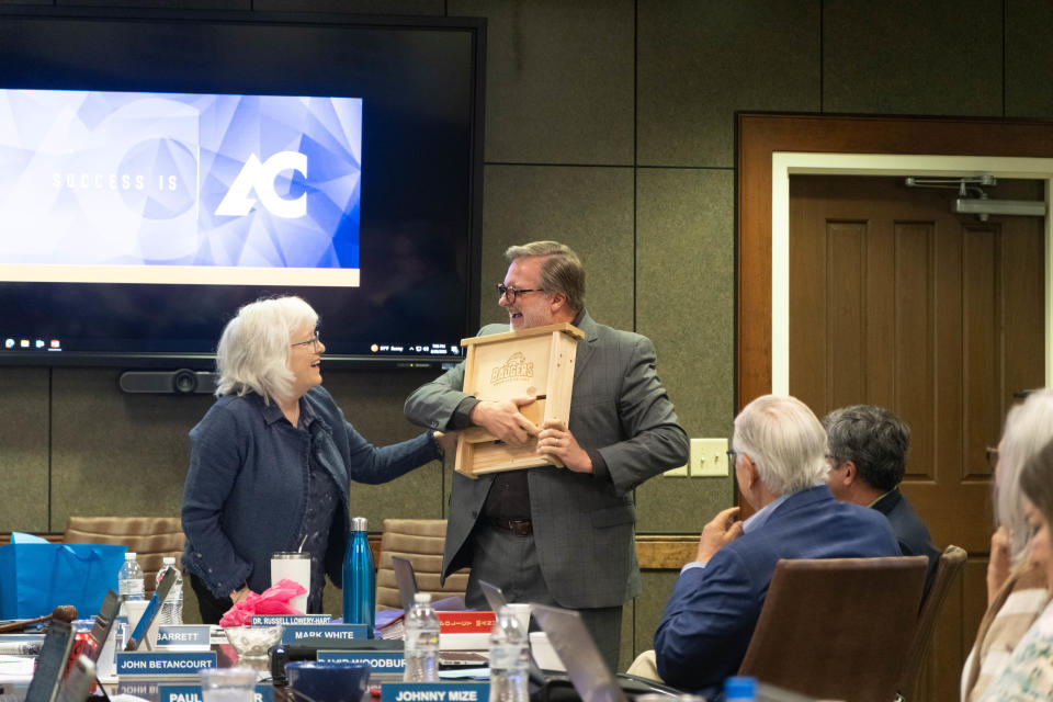 Departing Amarillo College President Russell Lowery-Hart reacts to his his going away gift a custom Amarillo College bat house at his last Members of the Board of Regents of the Amarillo Junior College District meeting in Amarillo.