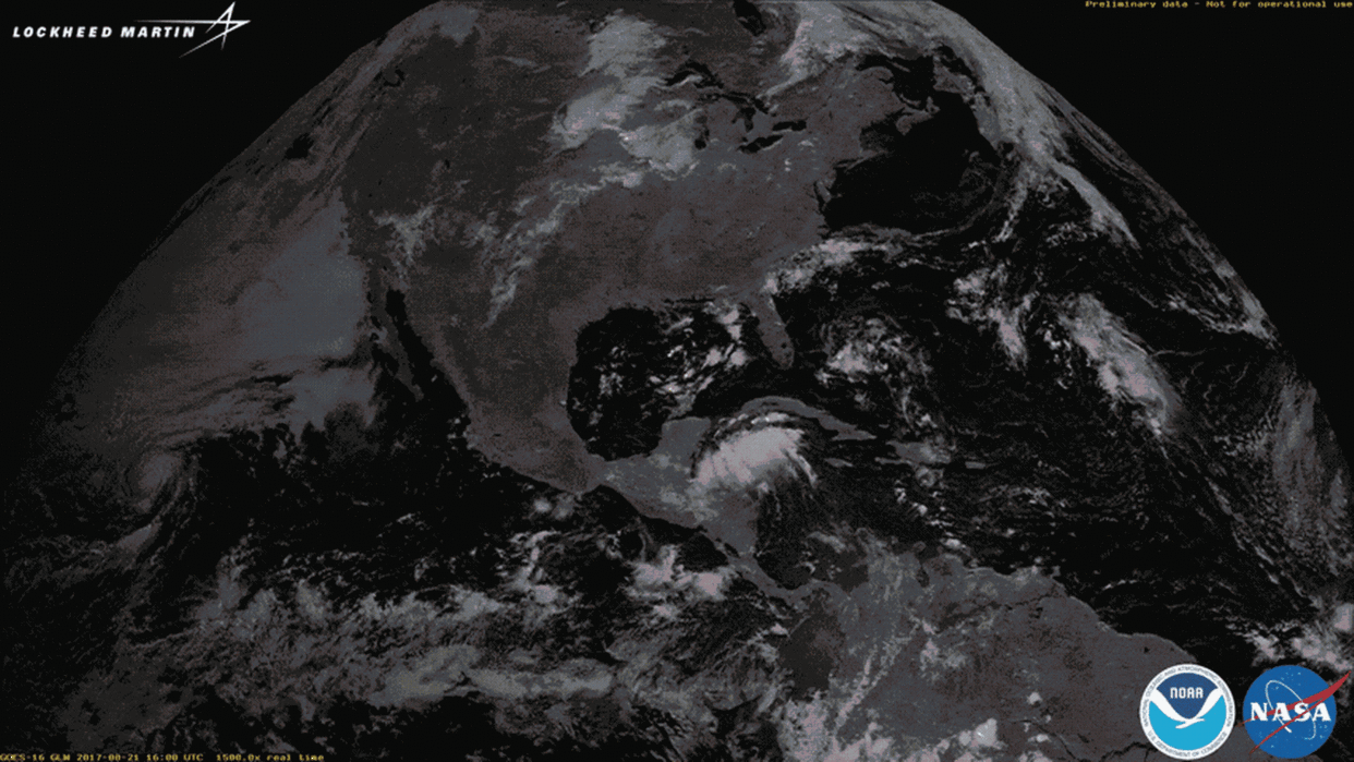 Lightning flashes illuminate the shadow of the moon during the transit of the solar eclipse on Aug. 21. <cite>Lockheed Martin</cite>