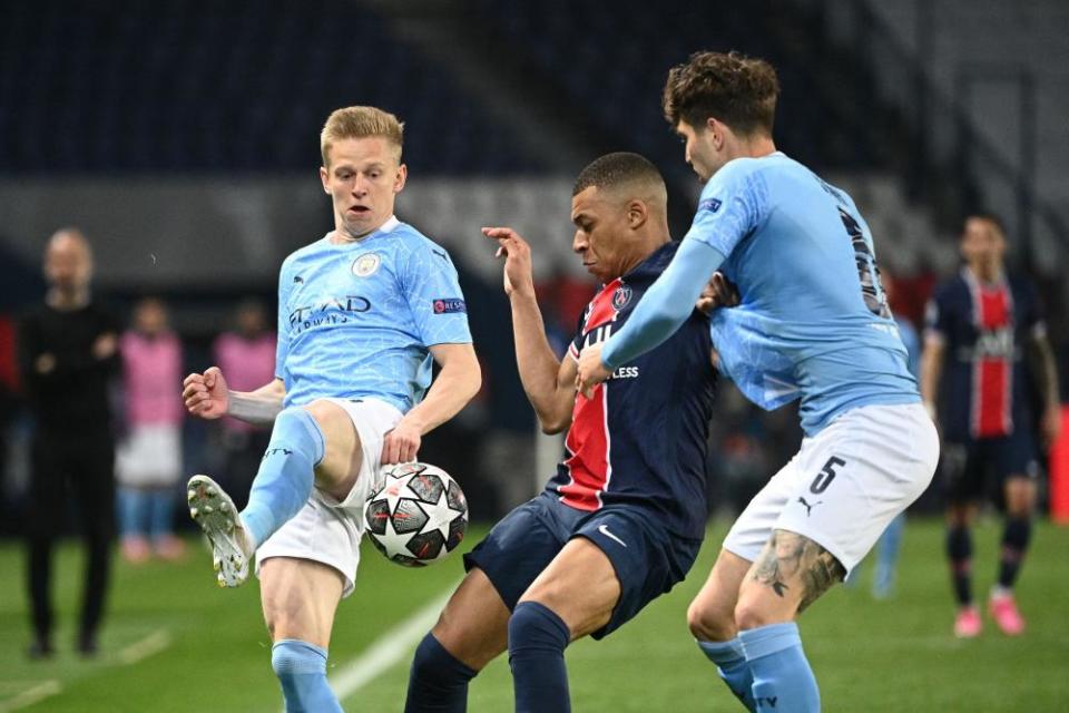 Kylian Mbappé is hustled off the ball by John Stones and Oleksandr Zinchenko. City restricted PSG to one set-piece goal in their two-leg tie.