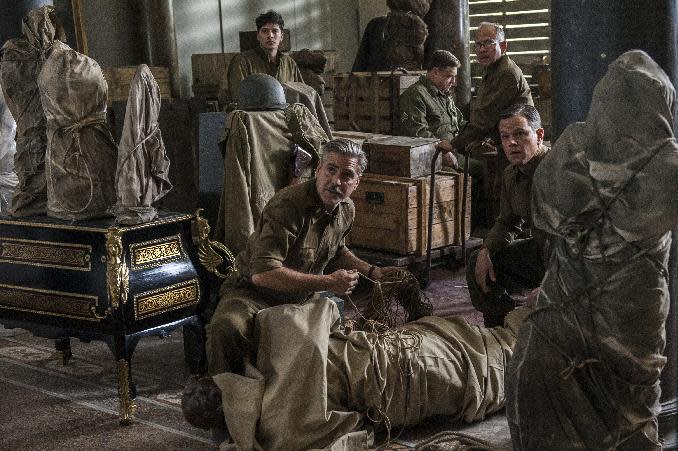 This image released by Columbia Pictures shows, from left, Dimitri Leonidas, George Clooney, John Goodman, Bob Balaban and Matt Damon in the film, "The Monuments Men." The World War II drama opens Friday, Feb 7, 2014. (AP Photo/Columbia Pictures, Claudette Barius)