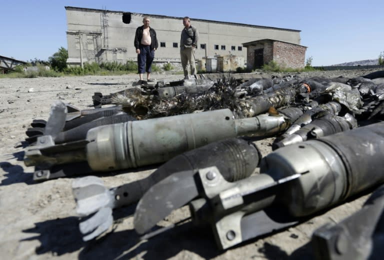 Residents of Kurdyumivka look at an ammunition depot of the Ukrainian forces destroyed by pro-Russian separatists with Russian Krasnopol guided shells after shelling on August 2, 2015, in the village of Kurdyumivka, Donetsk region