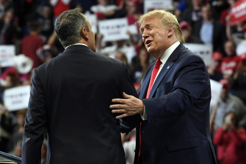 President Donald Trump, left, talks to Kentucky Gov. Matt Bevin, right, during a campaign rally in Lexington, Ky., Monday, Nov. 4, 2019. (AP Photo/Susan Walsh)