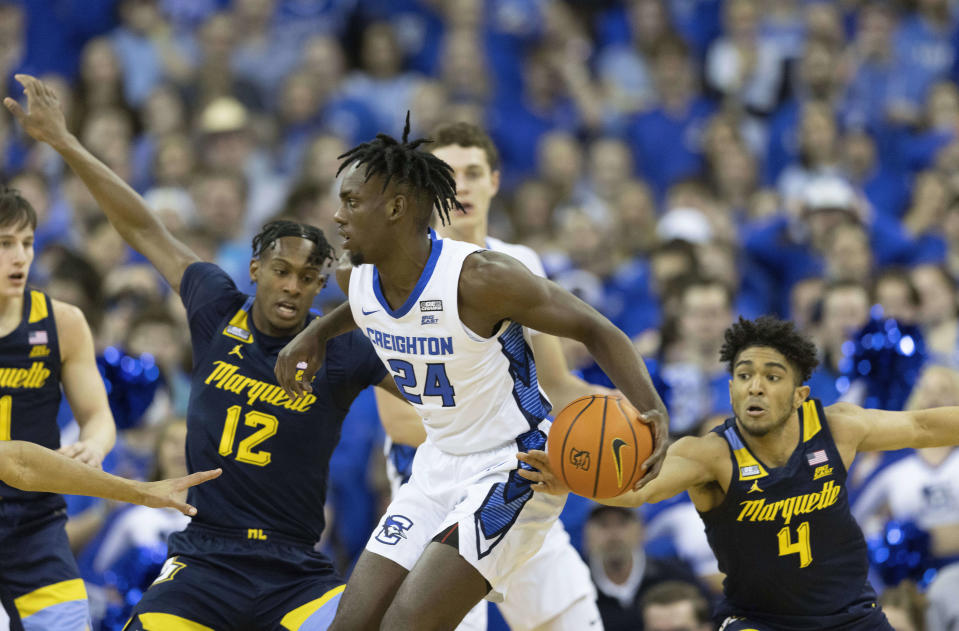 Marquette's Stevie Mitchell (4) steals the ball from Creighton's Arthur Kaluma (24) during the first half of an NCAA college basketball game on Tuesday, Feb. 21, 2023, in Omaha, Neb. (AP Photo/Rebecca S. Gratz)