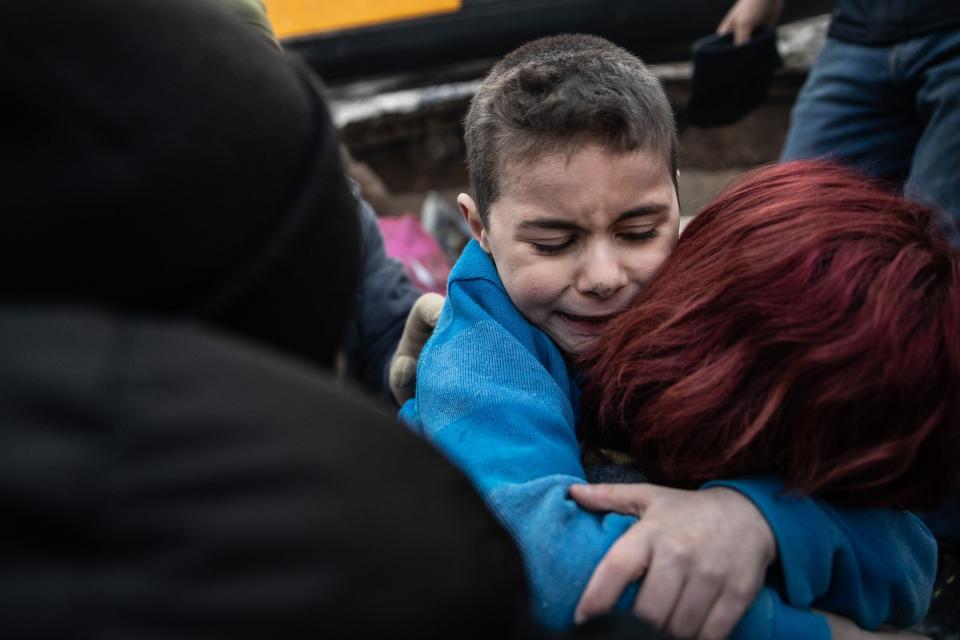 Yigit Cakmak, 8-years-old survivor at the site of a collapsed building, hugs his mother, after workers rescued him 52 hours after the earthquake struck, on February 08, 2023 in Hatay, Turkey.